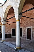 A round column (mid) and a polygonal column (left) of the courtyard’s colonnad