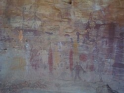 Aboriginal paintings on a rocky wall, depicting human figures