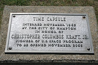 Metal plaque which reads: Time capsule interred November 1965 by the city of Hampton in honor of Christopher Columbus Kraft Jr. pioneer of U.S. space program to be opened November 2065