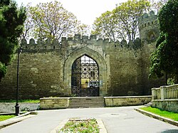 Large black gate through a wall